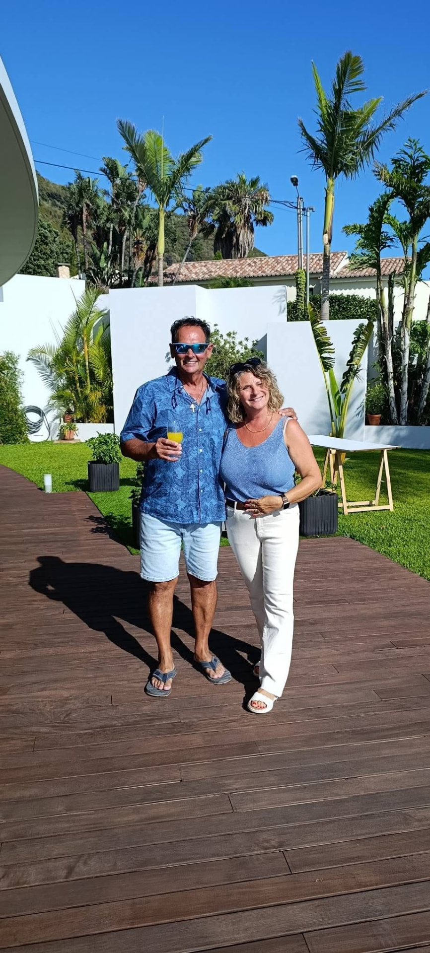Nathalie and Patrice in a garden filled with palms